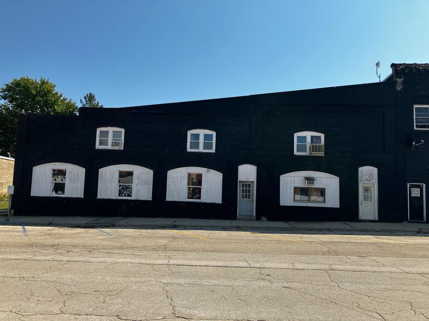 a front view of a building with parking space