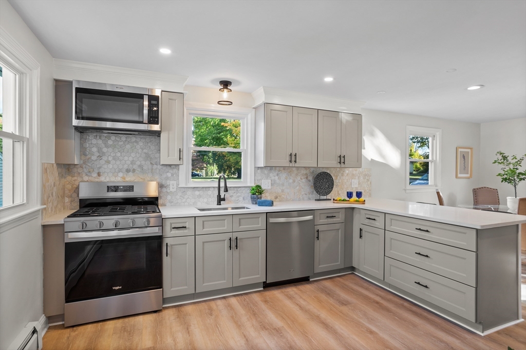 a kitchen with a stove top oven sink and cabinets