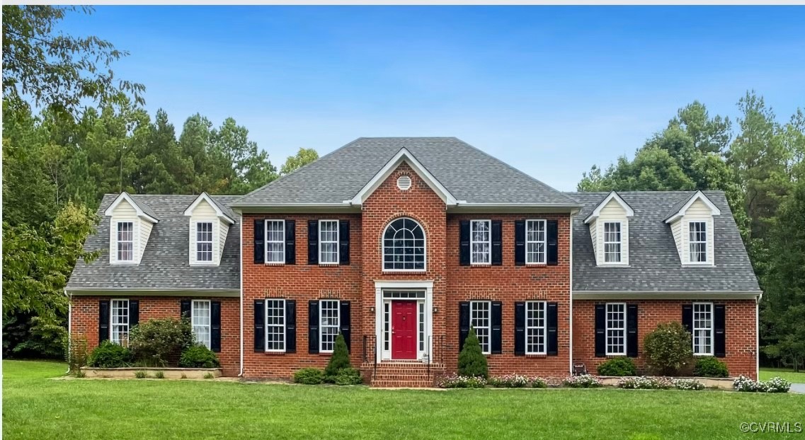 front view of brick house with a yard