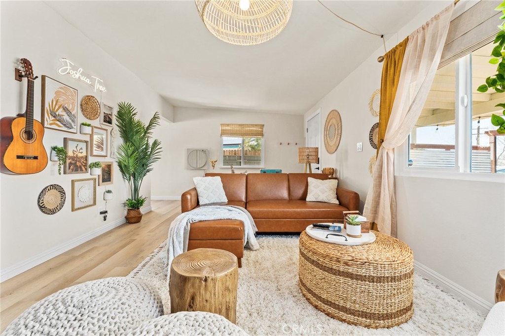 a living room with patio furniture and a chandelier