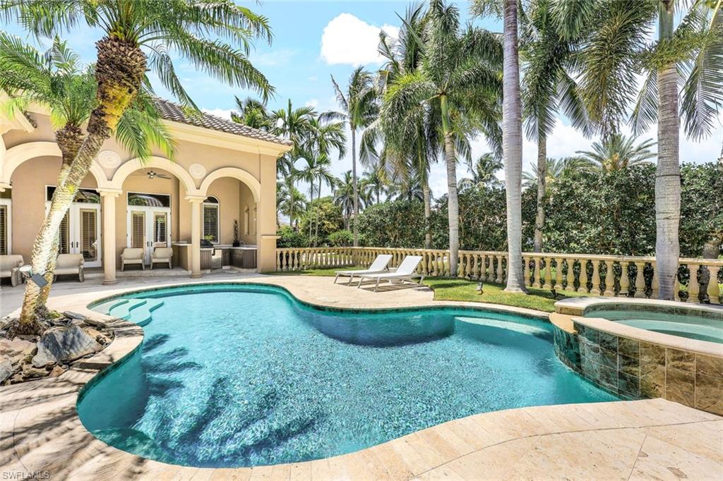 a view of a house with swimming pool and sitting area