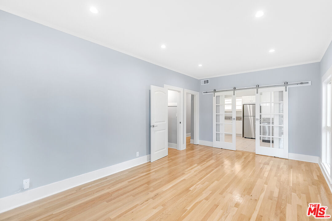 a view of empty room with wooden floor