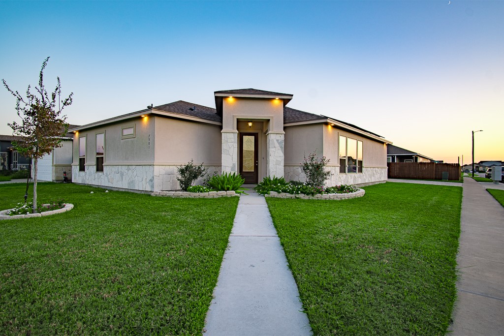 a front view of a house with garden