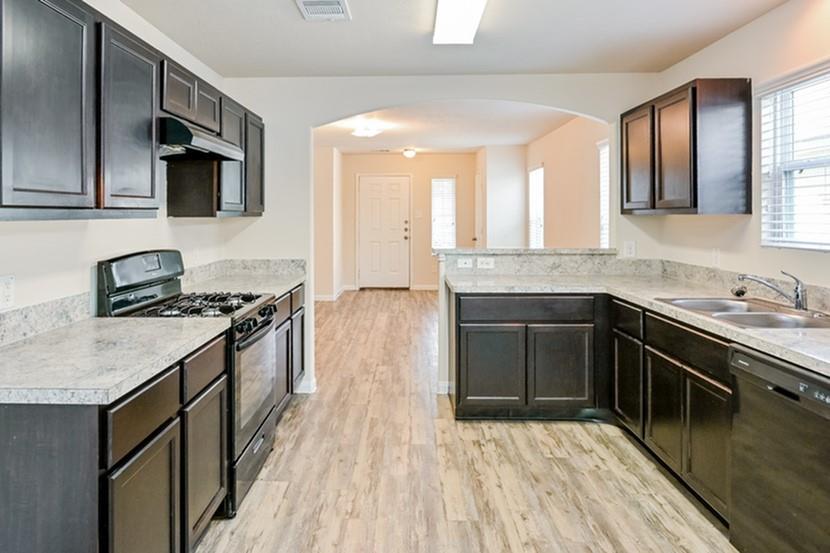 a kitchen with stainless steel appliances granite countertop a stove and a sink