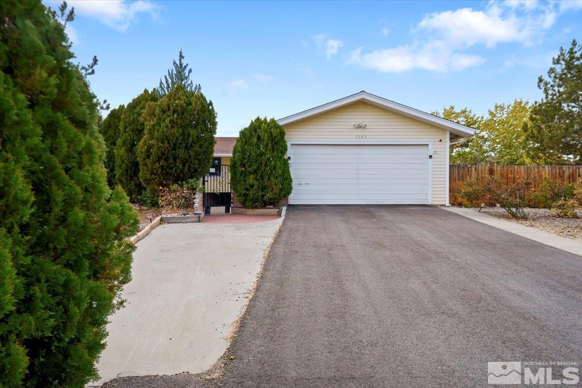 a view of a house with a yard and pathway