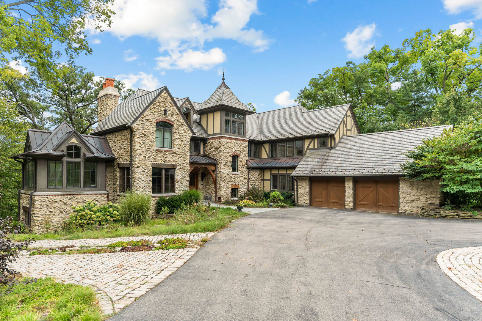 a front view of a house with a garden