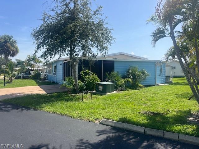 View of home's exterior with a yard