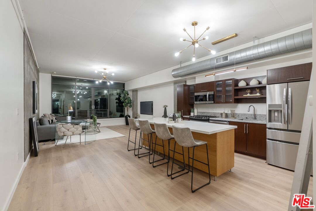 a large kitchen with a table and chairs