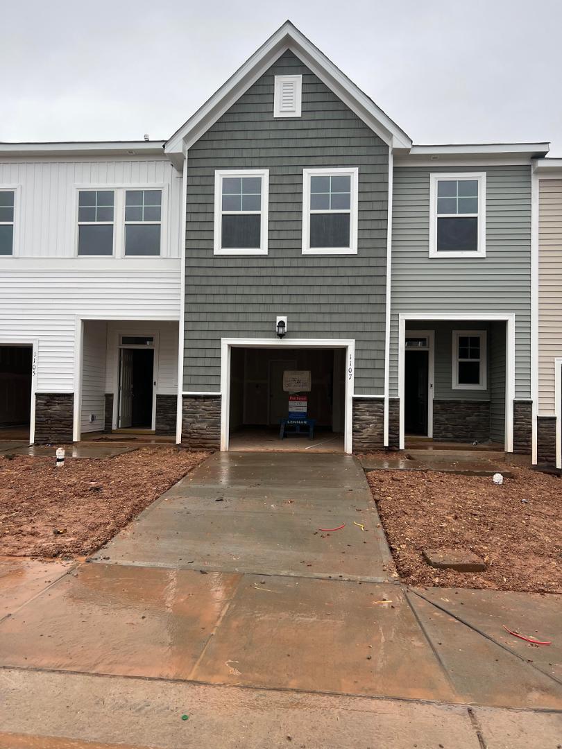 a front view of a house with yard