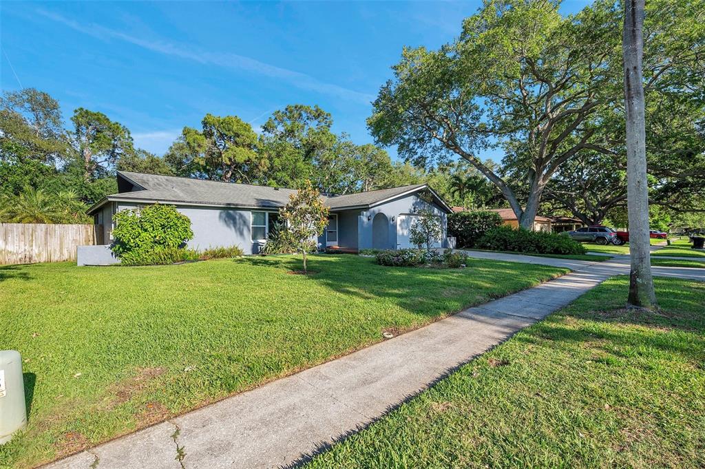 a view of house with backyard