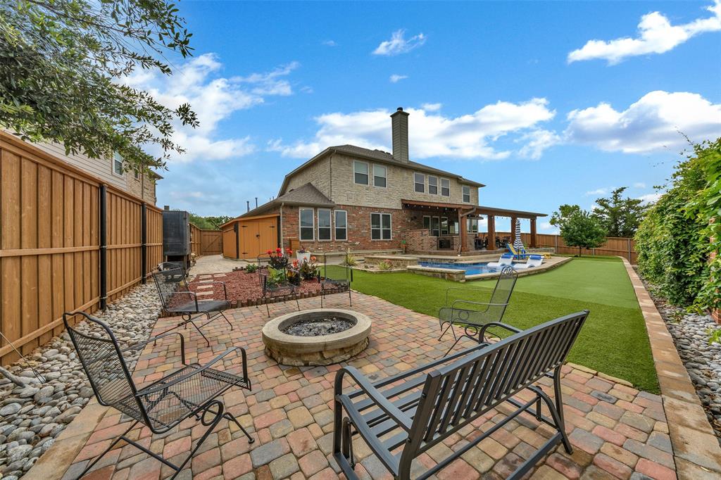 a view of a house with backyard and sitting area