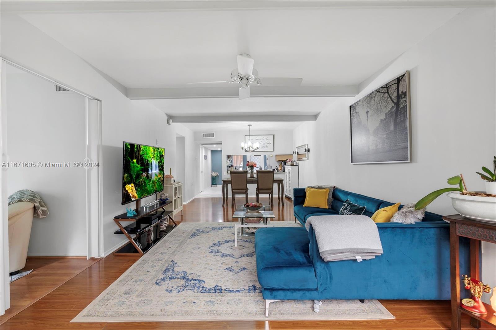 a living room with patio furniture and a wooden floor