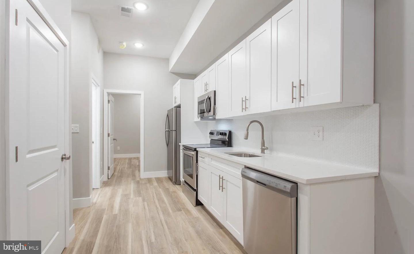 a view of a kitchen with electric appliances