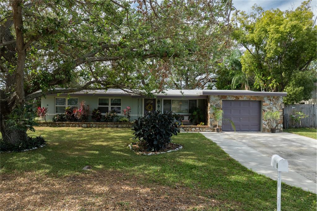 a front view of house with a garden and porch