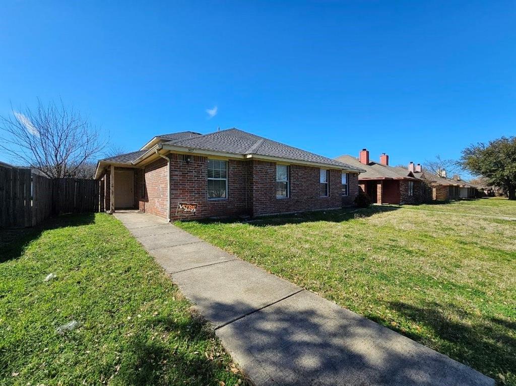 a front view of a house with a garden and yard