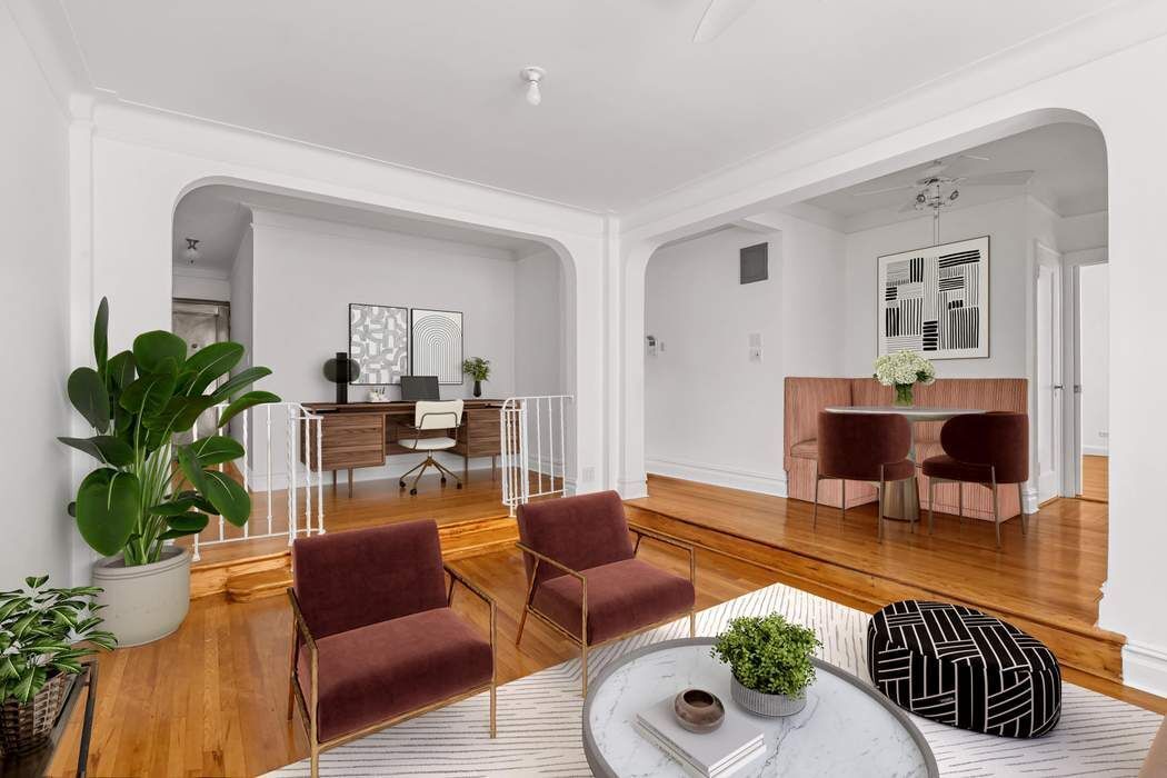 a living room with furniture and a potted plant