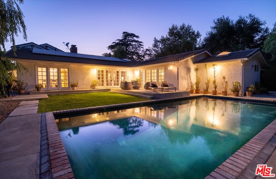 a view of a swimming pool with an outdoor seating