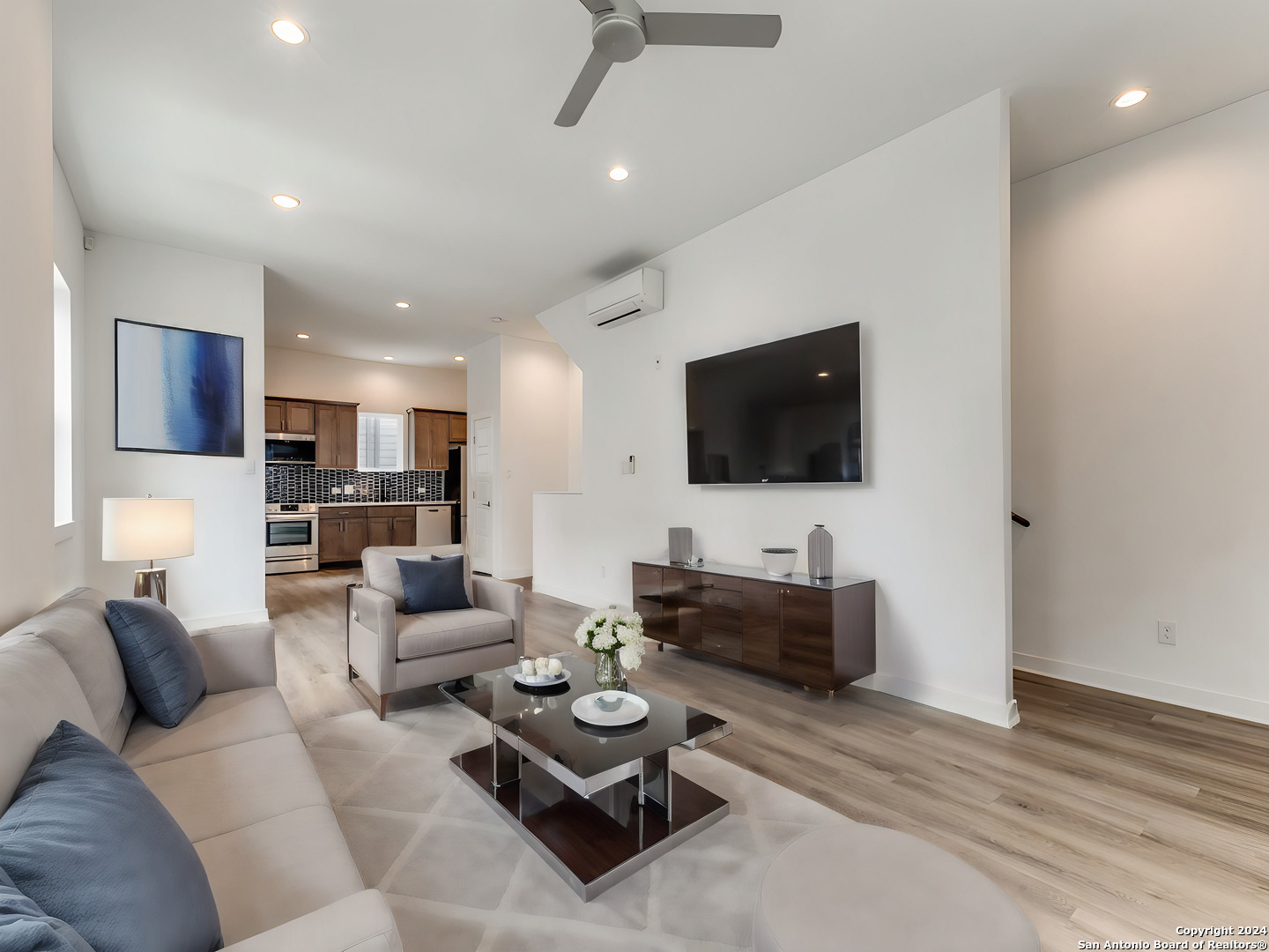 a living room with furniture and a flat screen tv