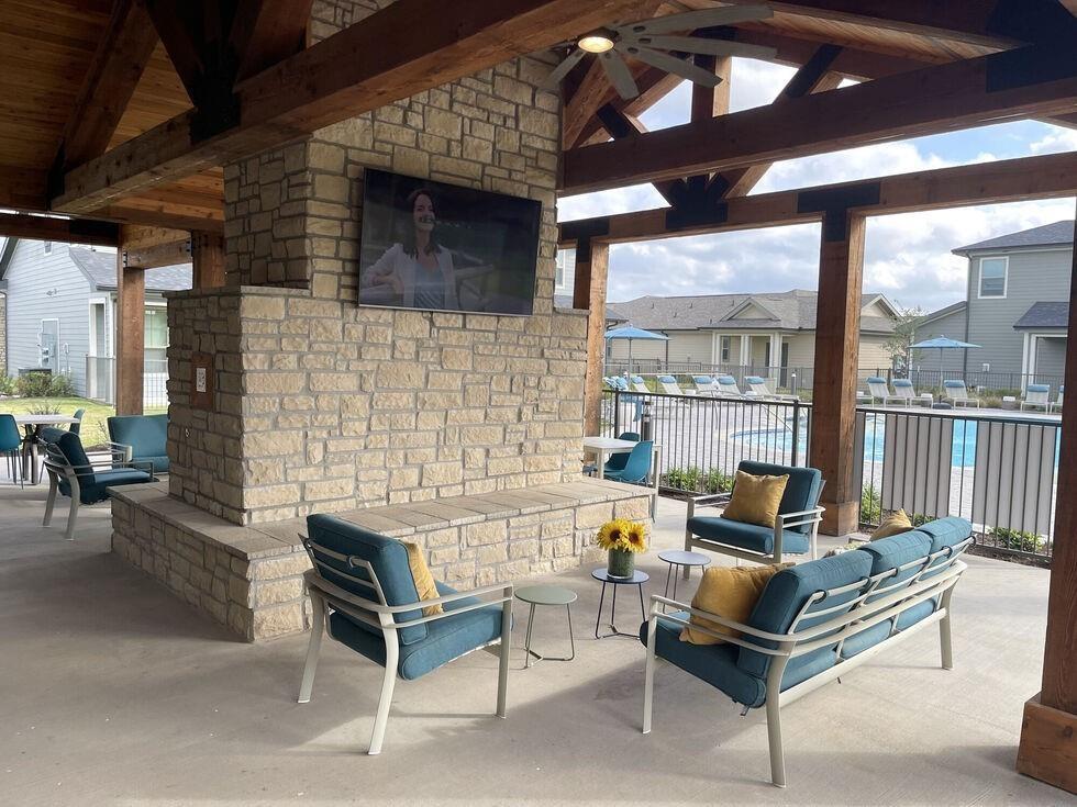 a outdoor living space with furniture and a fireplace