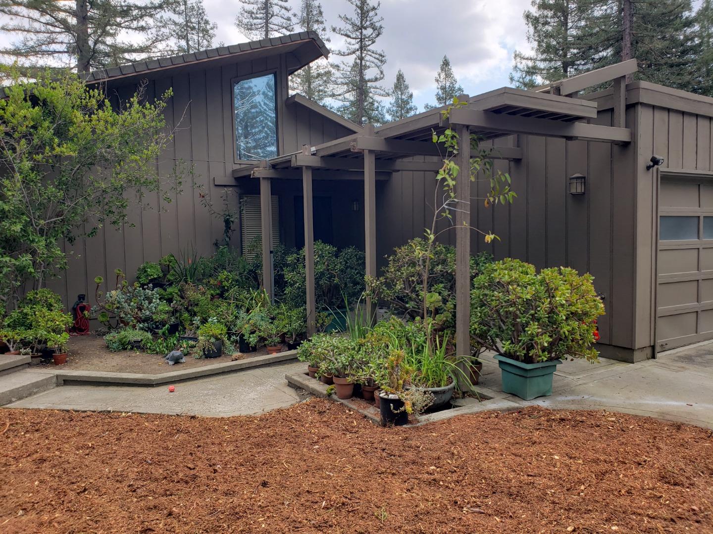 a view of a house with potted plants