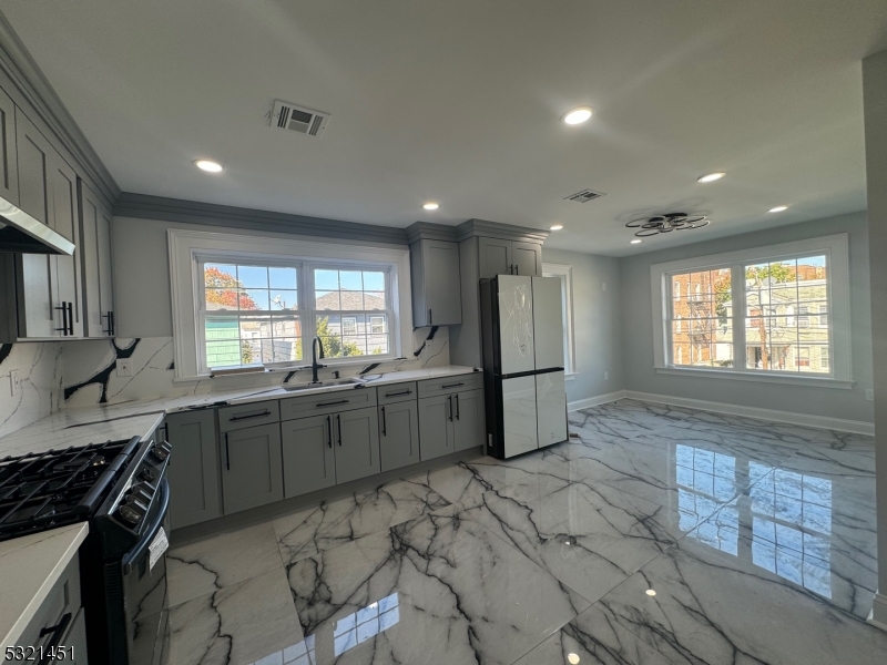 a kitchen with stainless steel appliances granite countertop a sink stove and granite counter top