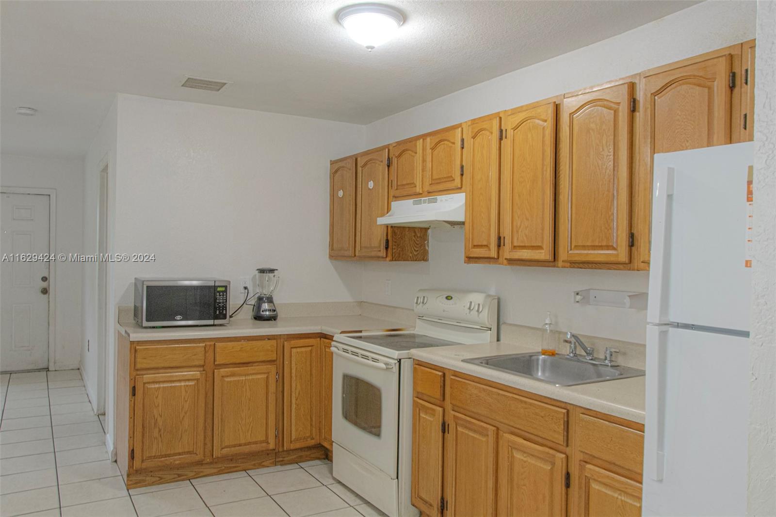 a kitchen with a sink a stove and cabinets