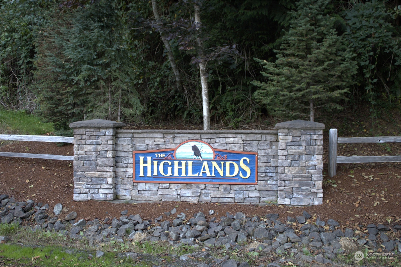 a view of a street sign under a large tree