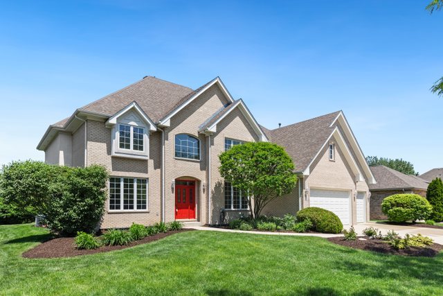 a front view of a house with a yard and garage