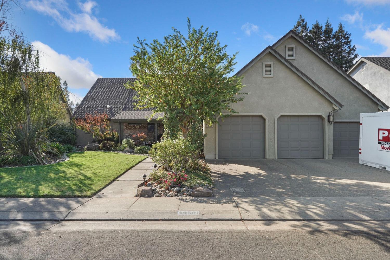 a front view of a house with a yard and garage