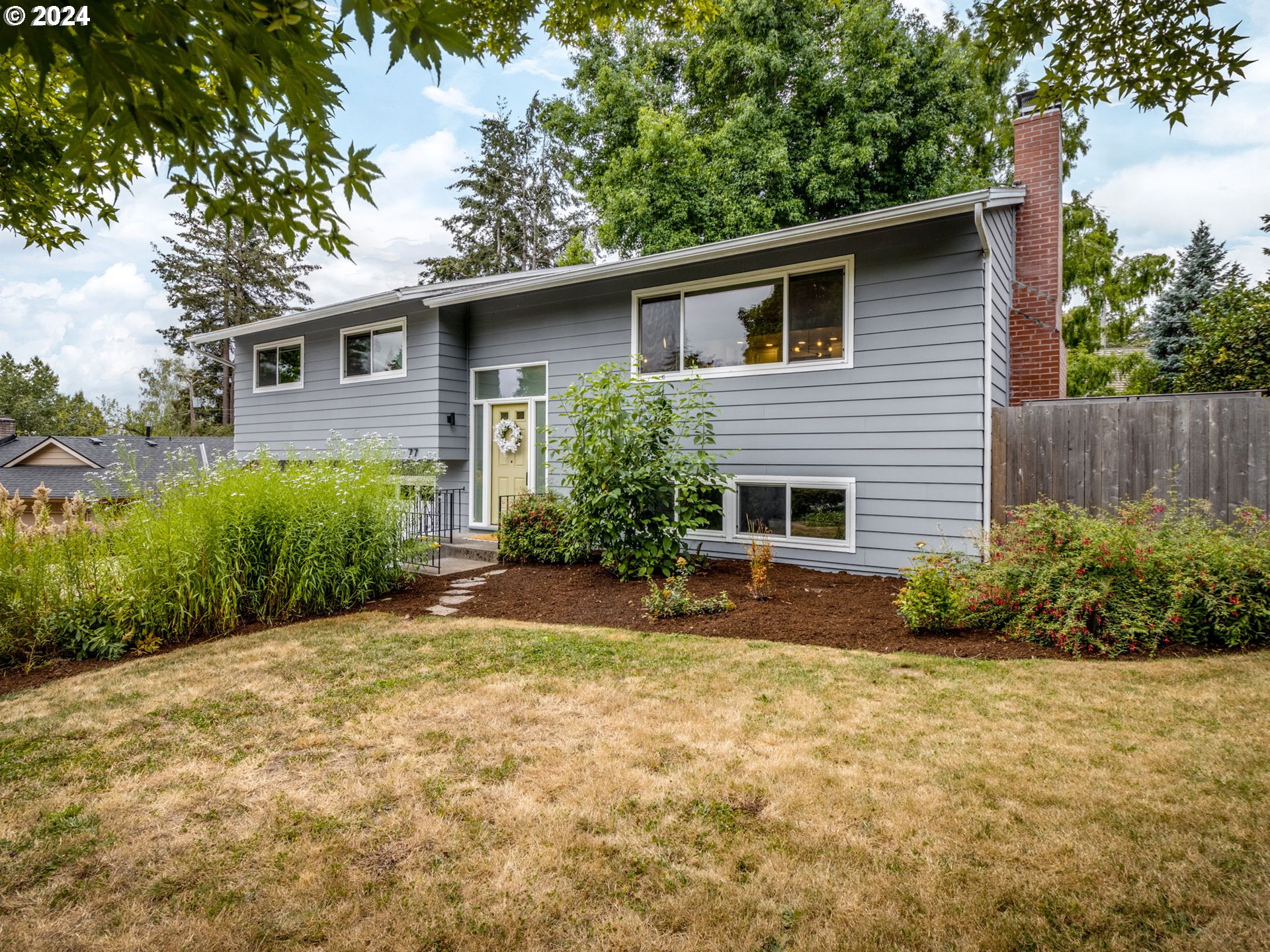 a view of a house with a yard and plants