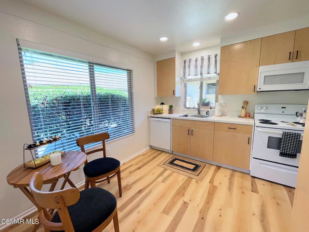 a kitchen with stainless steel appliances kitchen island granite countertop a sink and cabinets