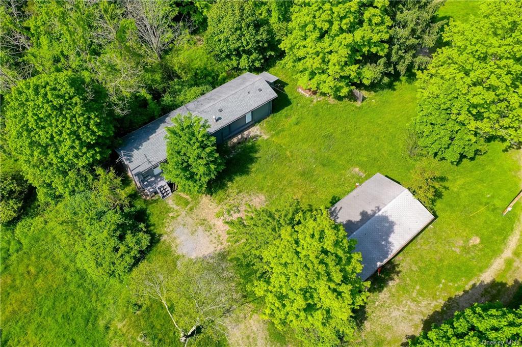 an aerial view of a house with a yard swimming pool and outdoor seating