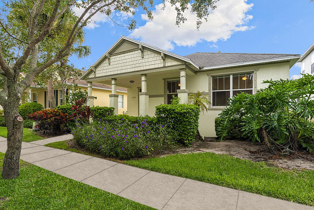 a front view of a house with a garden