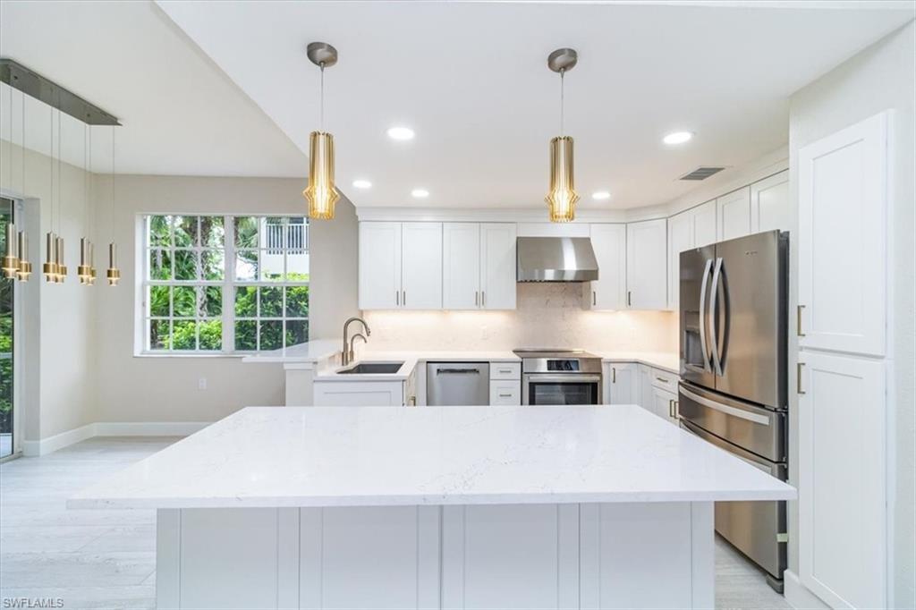 a kitchen with stainless steel appliances a refrigerator sink and window