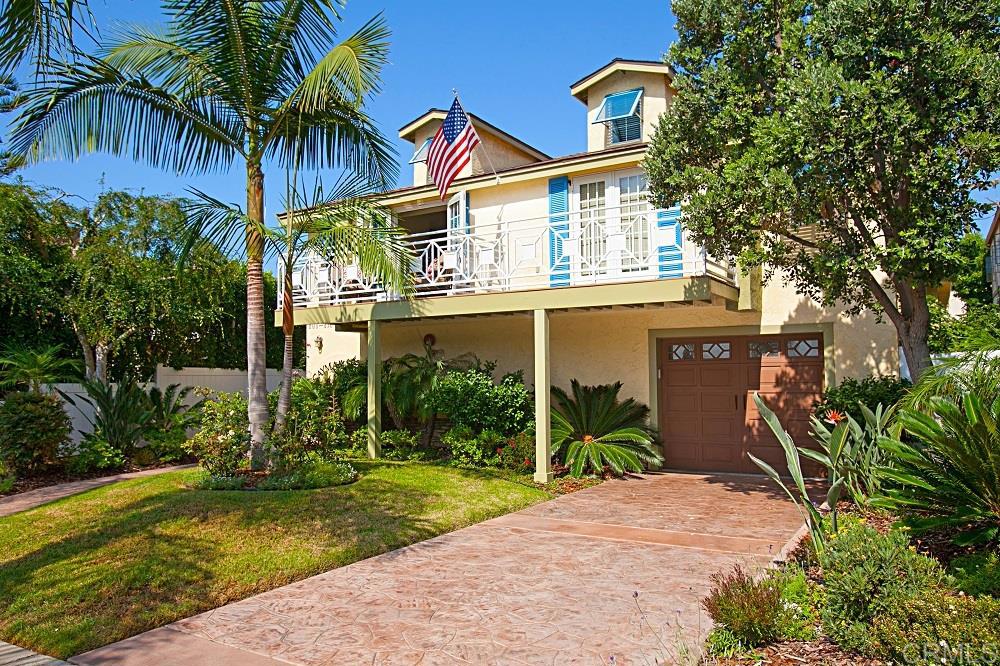 a view of a house with a yard and potted plants