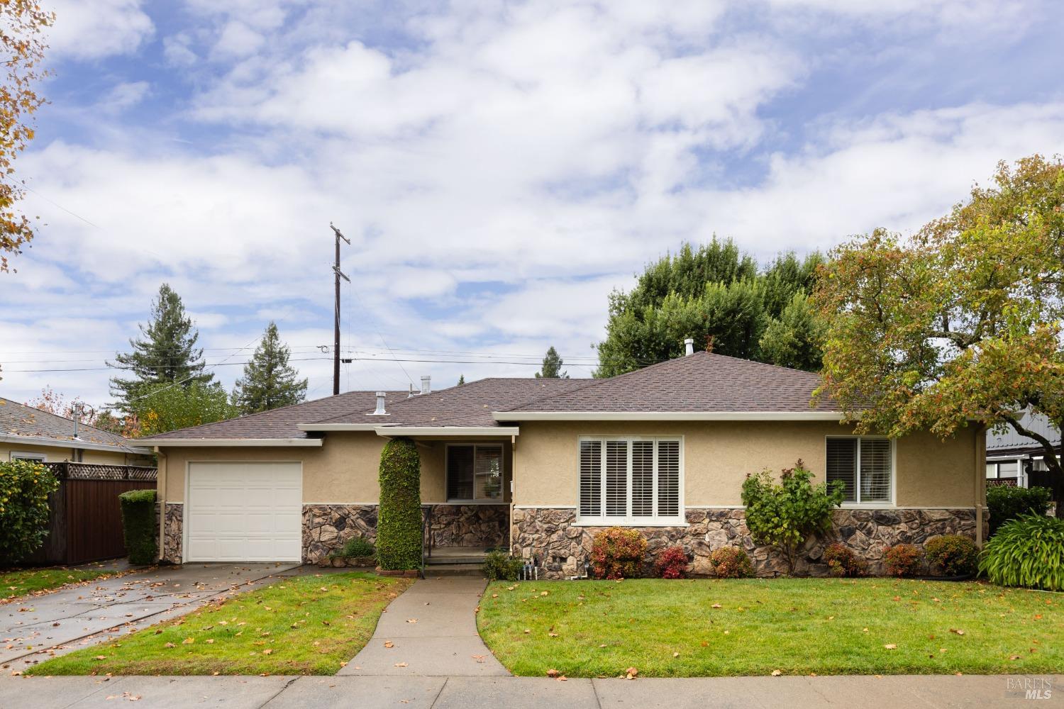 a front view of a house with garden