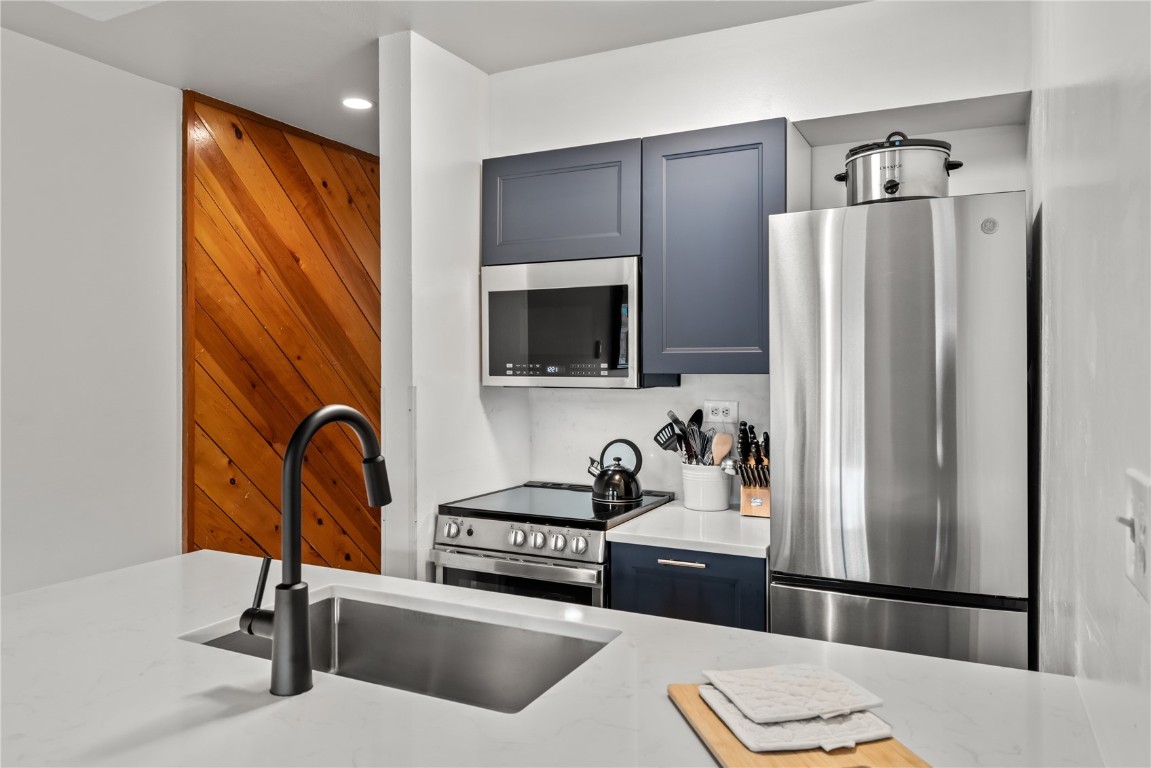 a kitchen with a refrigerator and a sink