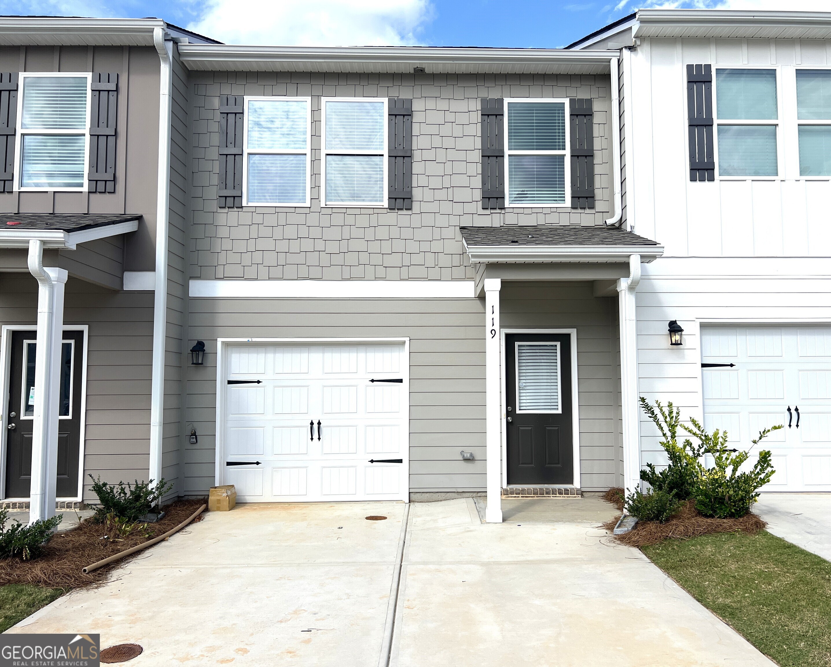 a front view of a house with a yard and garage