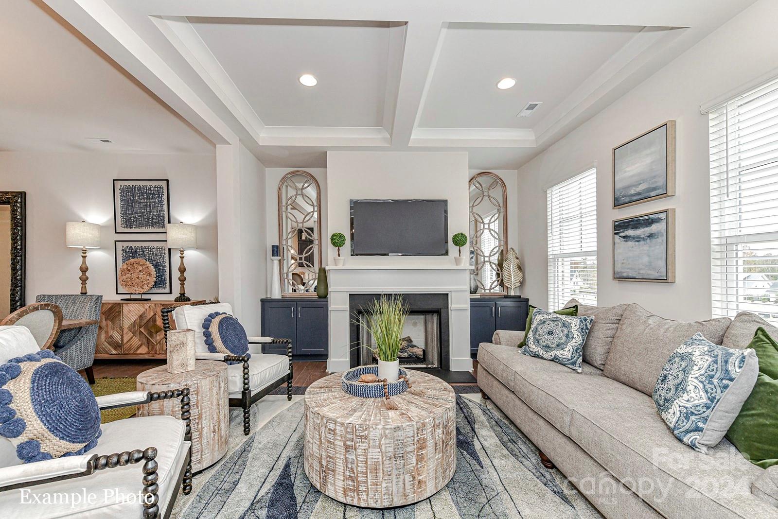 a living room with furniture fireplace and a window