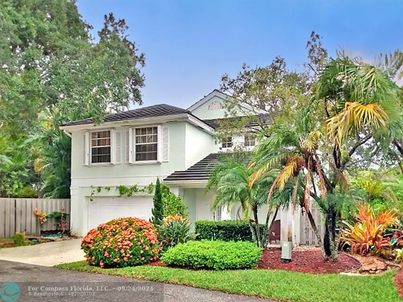 a front view of a house with a garden