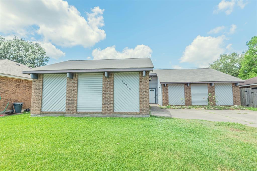 a view of a house with a yard and fence