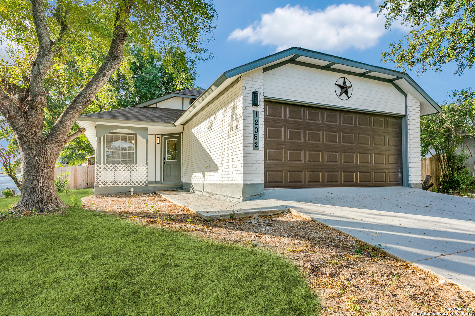 a front view of a house with a yard and garage