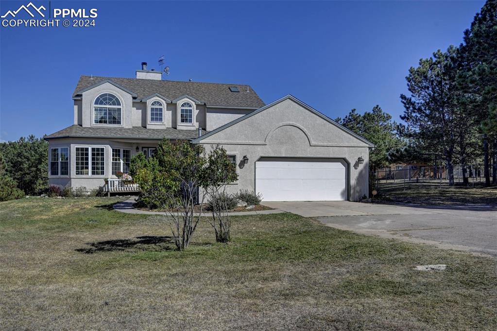 a front view of a house with a yard and garage