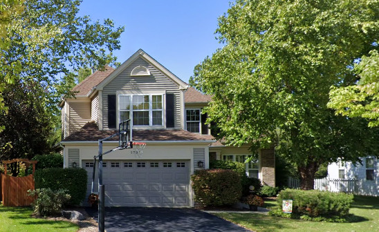 a view of house with yard and outdoor seating