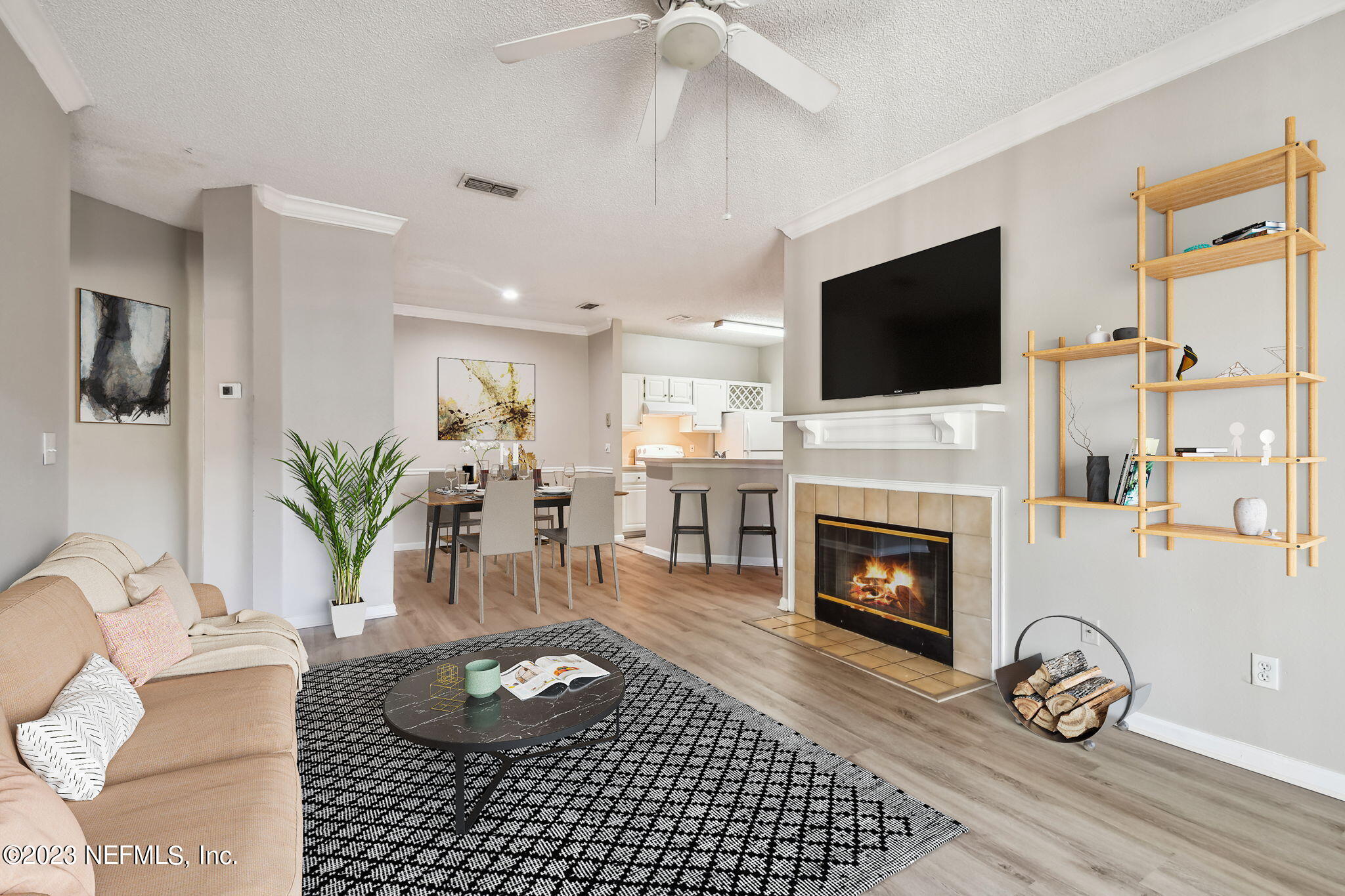 a living room with furniture a fireplace and a flat screen tv