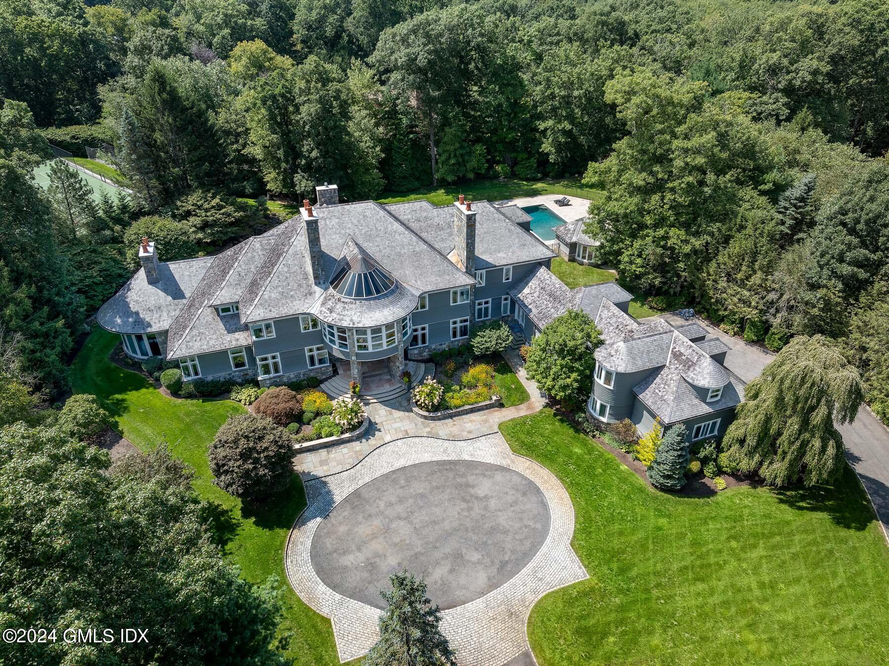 an aerial view of a house with swimming pool a yard and outdoor seating