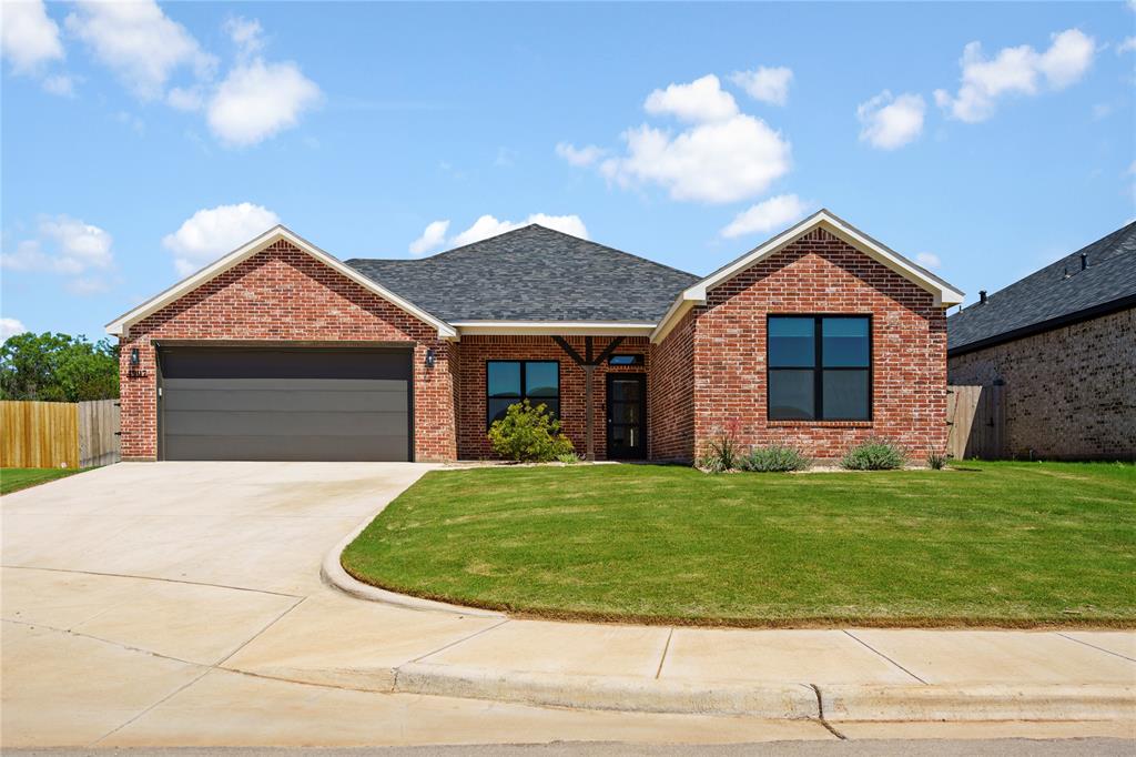 a front view of a house with a garden and yard