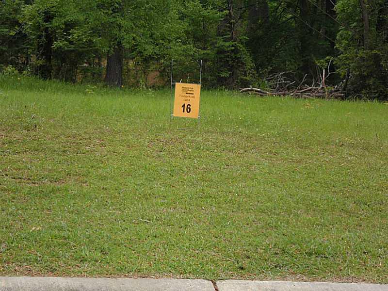 a sign of golf club on a wall under a green field