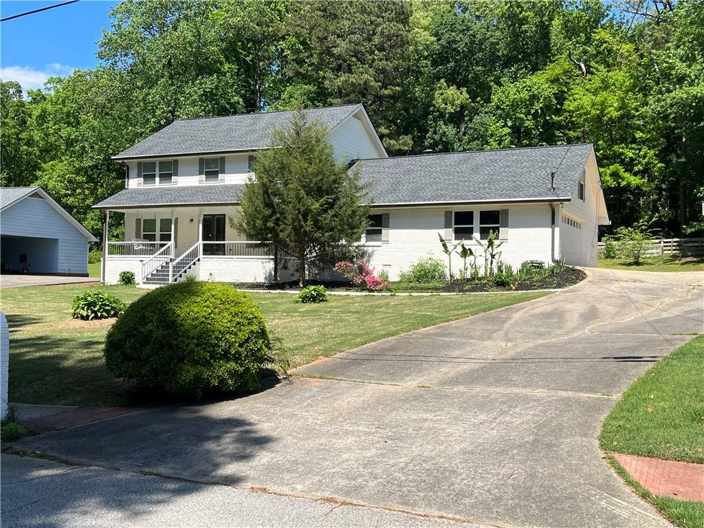 a front view of a house with a garden