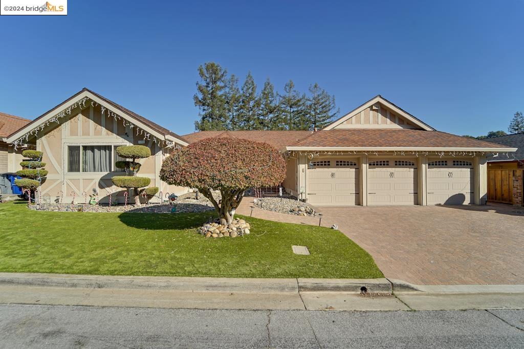 a front view of a house with a yard and garage